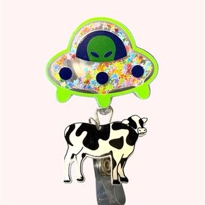 Green Alien UFO Badge Reel with Black-and-White Cow Charm